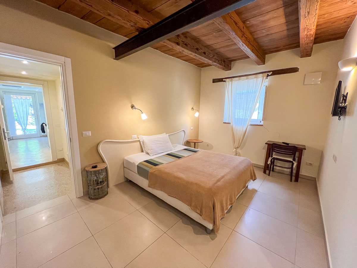 A bed in the room at one of the agriturismi (farm stays) where sleep on an organic vineyard during our Italy bike trip in the Marche region. ©KettiWilhelm2025