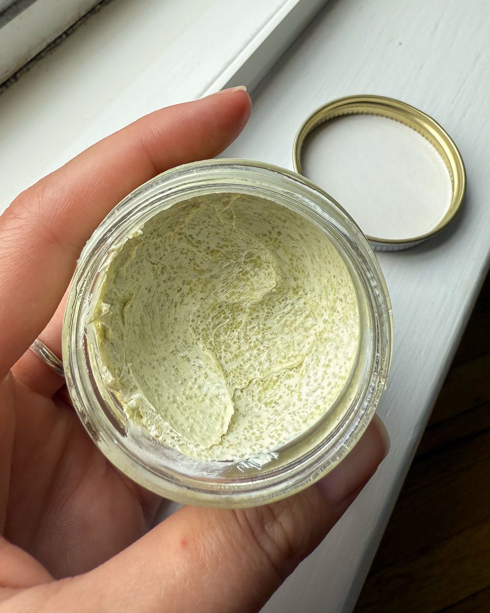 Open glass jar of mineral suncream from Circular Bodies, showing the slight separation of the natural, organic, biodegradable ingredients. ©KettiWilhelm2025