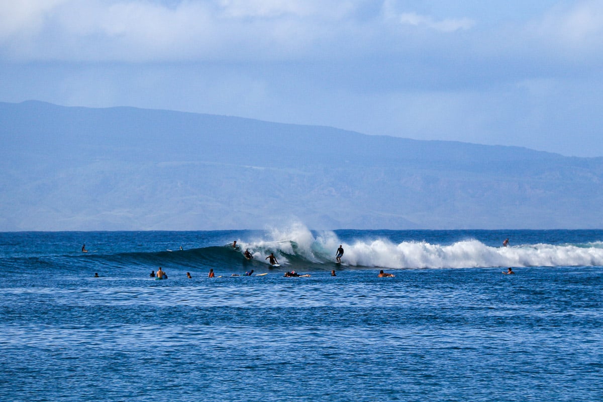 Surfers ride a wave in Hawaii, where chemical sunscreens are illegal and natural, mineral sunscreens are the only kind allowed. ©KettiWilhelm2025