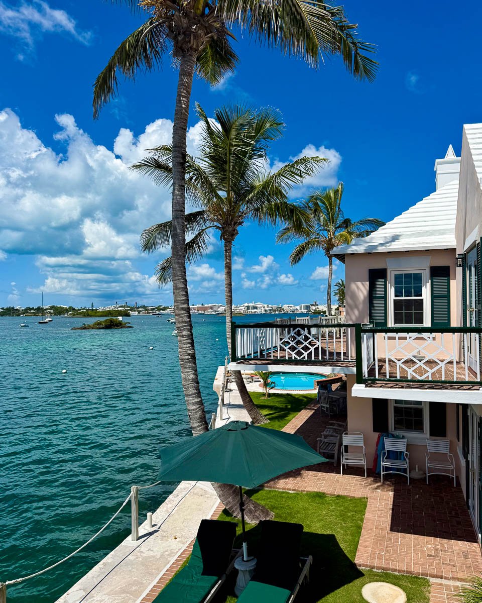 Bright blue sky and palm trees next to the Watercolours B&B, a locally owned Bermuda hotel. ©KettiWilhelm2025