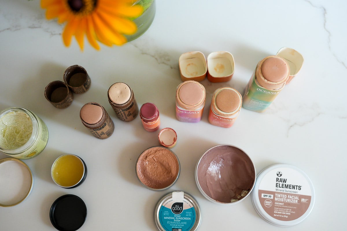 My collection of plastic-free, organic sunscreens for face, including tinted mineral sunscreens from Avasol, Raw Elements, Palm and Pine, All Good, and ATTITUDE, and non-tinted face sunscreens from Earth Harbor and Circular Bodies. ©KettiWilhelm2025