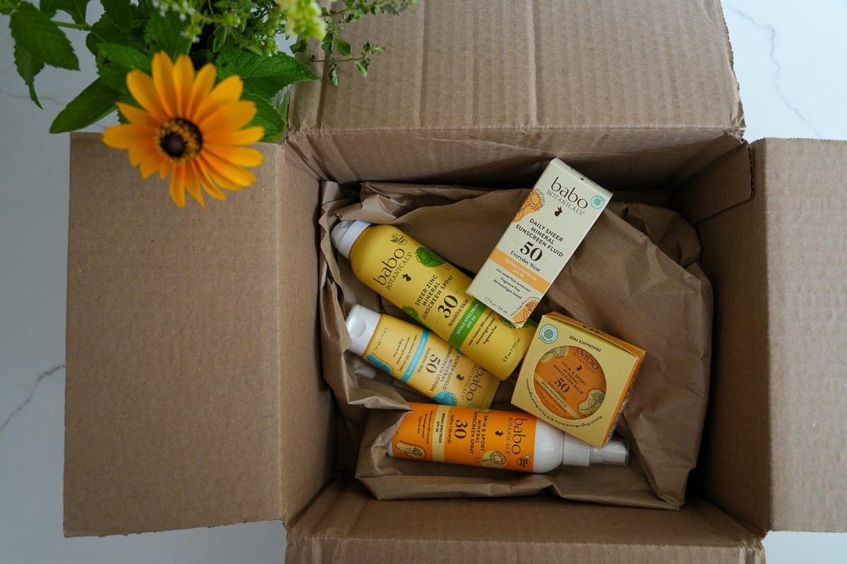 Chemical-free (mineral) sunscreens from Babo Botanicals in the paper shipping materials they arrived at my house in. ©KettiWilhelm2026