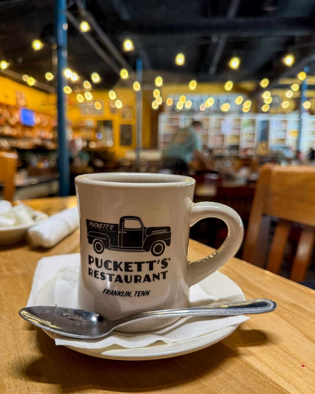 A coffee cup from Puckett's Restaurant, a classic Southern diner in Franklin, Tennessee. ©KettiWilhelm2026