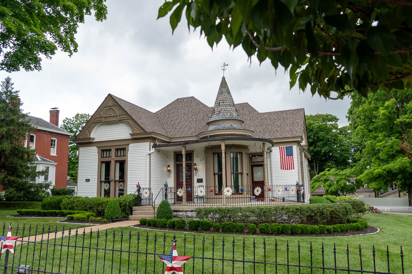 Historic home with a turret decorated with American flags in downtown Franklin, Tennessee. ©KettiWilhelm2026
