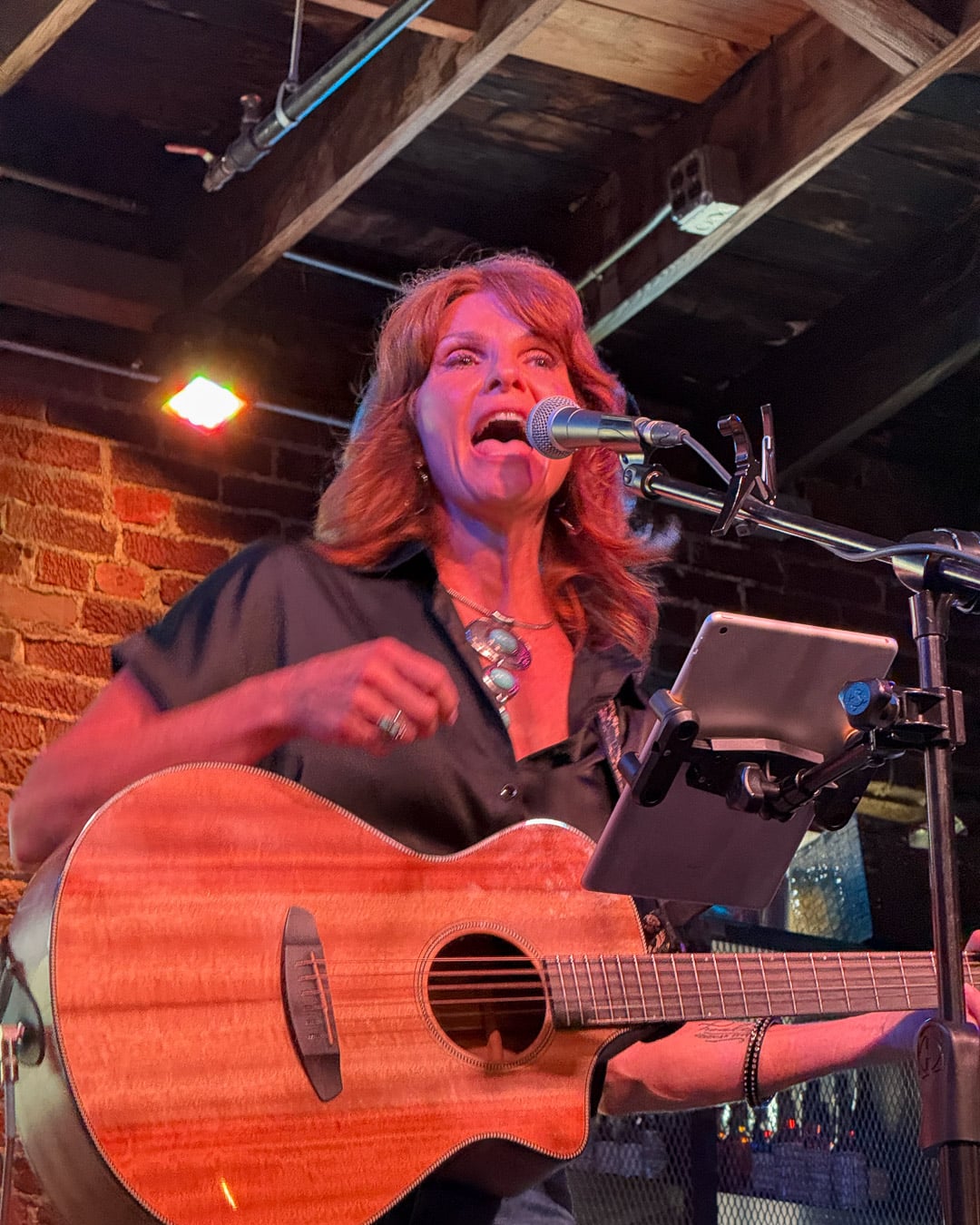 Nashville musician Rhonda Funk plays guitar and sings on stage at Grays on Main, one of the best dinner and music spots in Franklin, Tennessee. ©KettiWilhelm2026