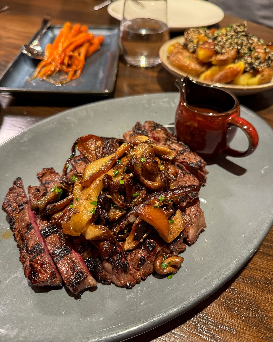 A ribeye steak from a local farm, covered in mushrooms, at the 1799 Restaurant, inside the Harpeth Hotel, a locally owned hotel that's part of Hilton's Curio Collection, in downtown Franklin, Tennessee. ©KettiWilhelm2026